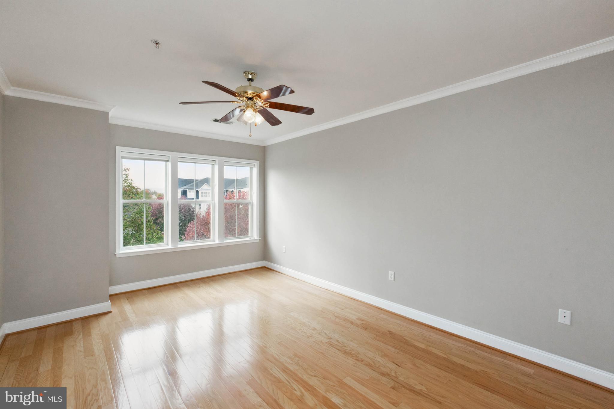 2500 Waterside Drive, Unit 405 Frederick, MD 21701 - Photo 30 of 45 Roomy primary bedroom with ceiling fan.