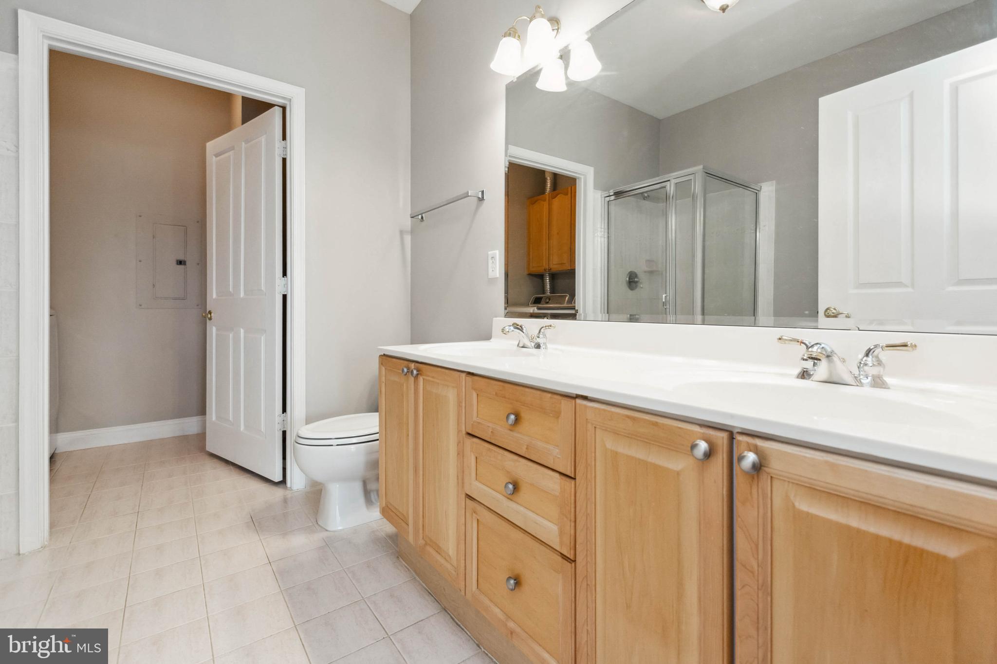 2500 Waterside Drive, Unit 405 Frederick, MD 21701 - Photo 34 of 45 Primary bathroom with dual vanity, tile floor