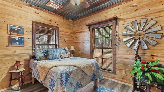 a bed sitting in a bedroom next to a brick wall