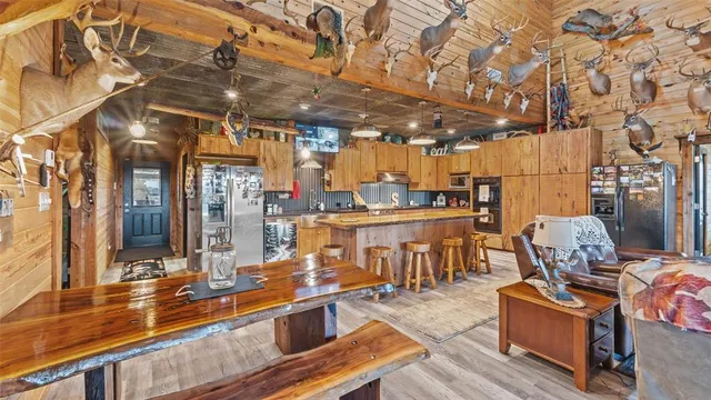a view of a patio with table and chairs and wooden floor