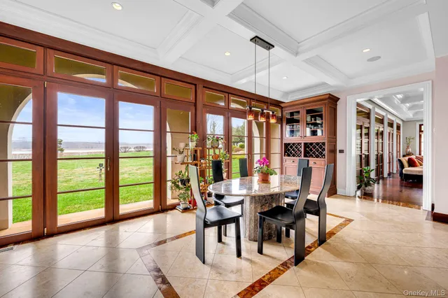 a dining room with furniture and large windows