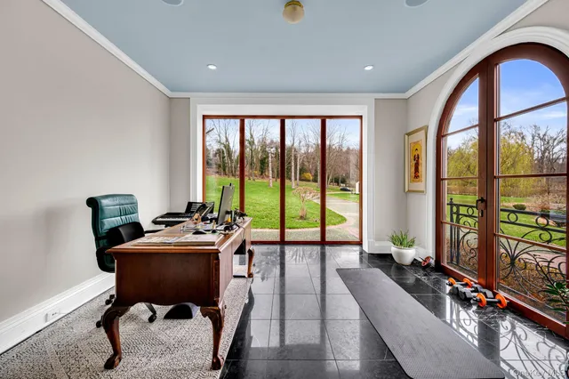 a room with furniture pool table and windows