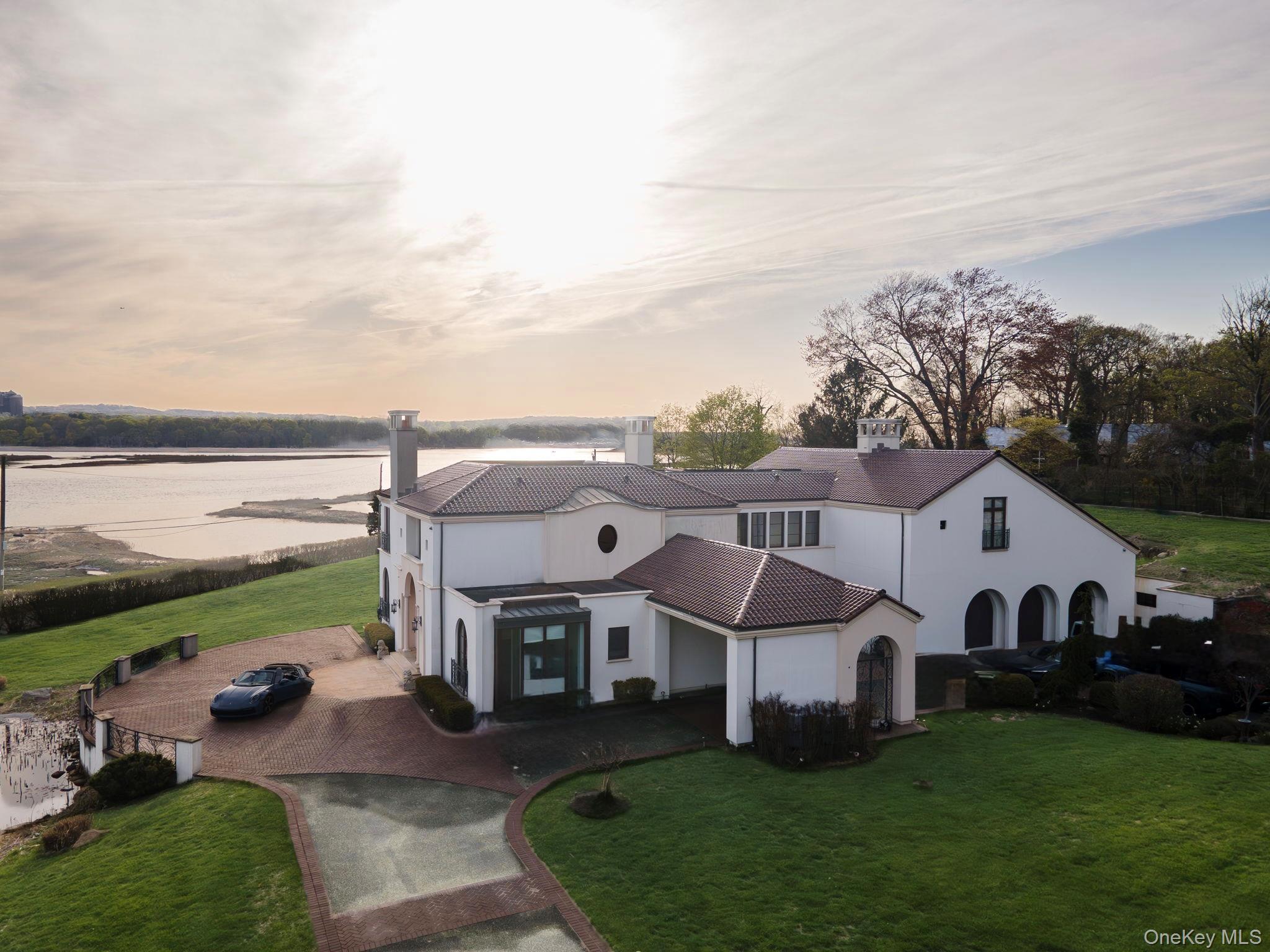 717 Short Beach Road St. James, NY 11780 - Photo 2 of 47 a view of a white house with a big yard and large trees