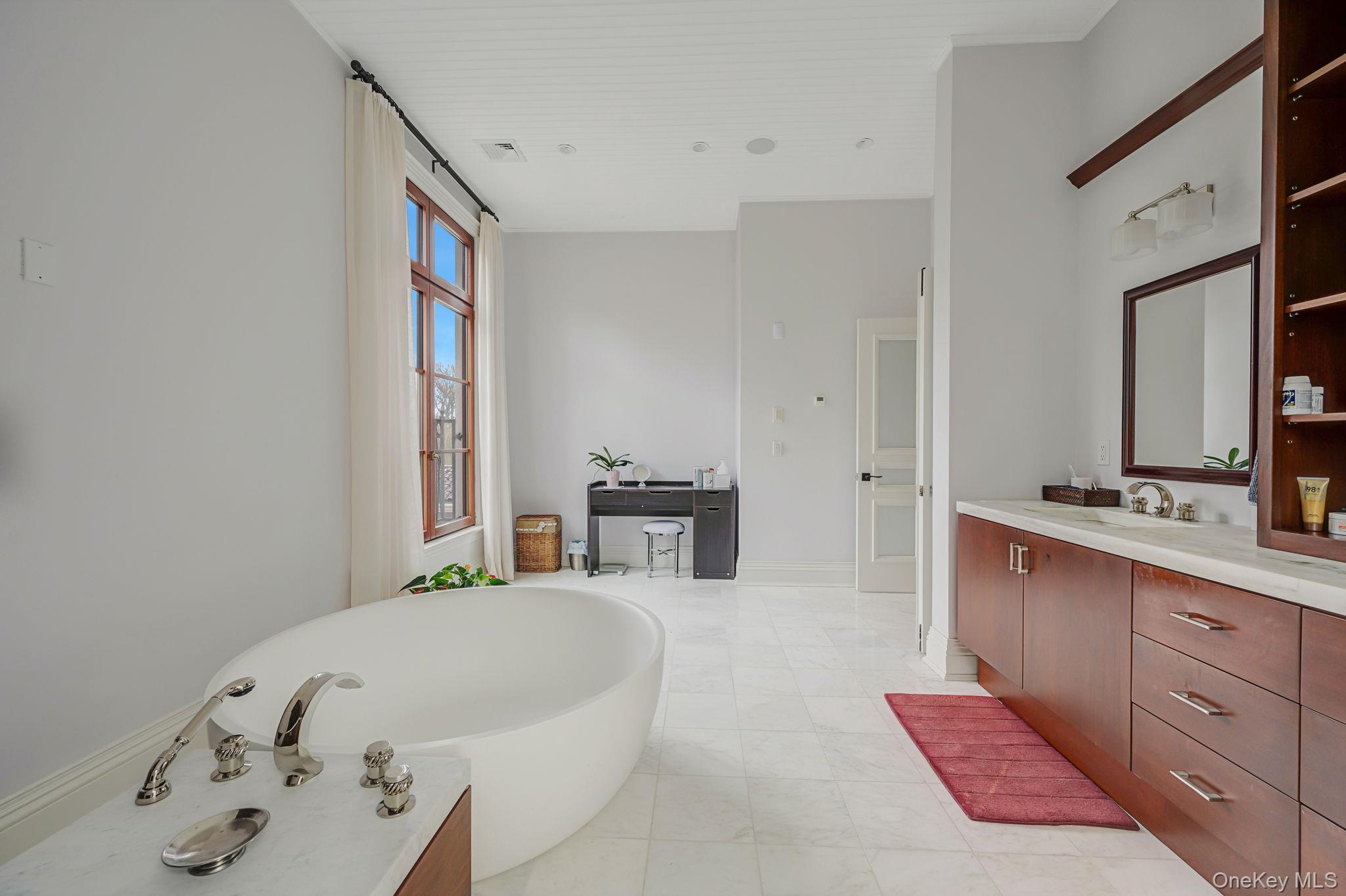 717 Short Beach Road St. James, NY 11780 - Photo 25 of 47 a spacious bedroom with a large bed and a bathtub