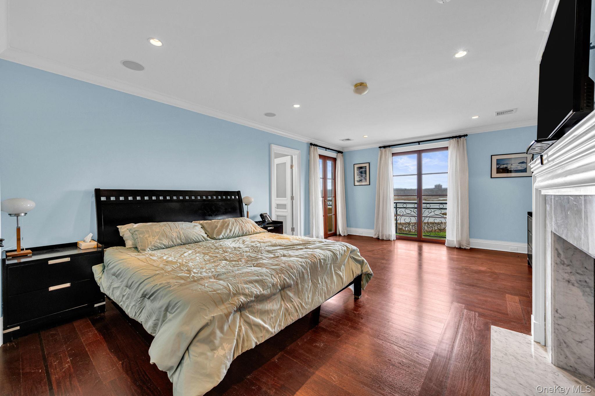 717 Short Beach Road St. James, NY 11780 - Photo 29 of 47 a spacious bedroom with a bed and a flat screen tv