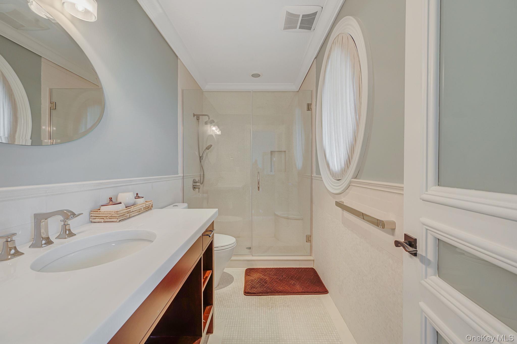 717 Short Beach Road St. James, NY 11780 - Photo 30 of 47 a bathroom with a sink a toilet and a mirror