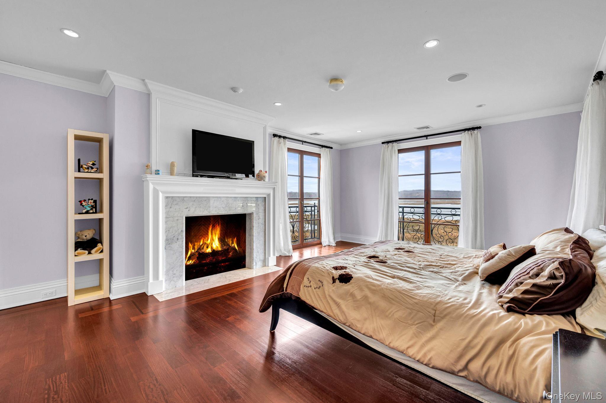 717 Short Beach Road St. James, NY 11780 - Photo 31 of 47 a bedroom with a bed and a fireplace