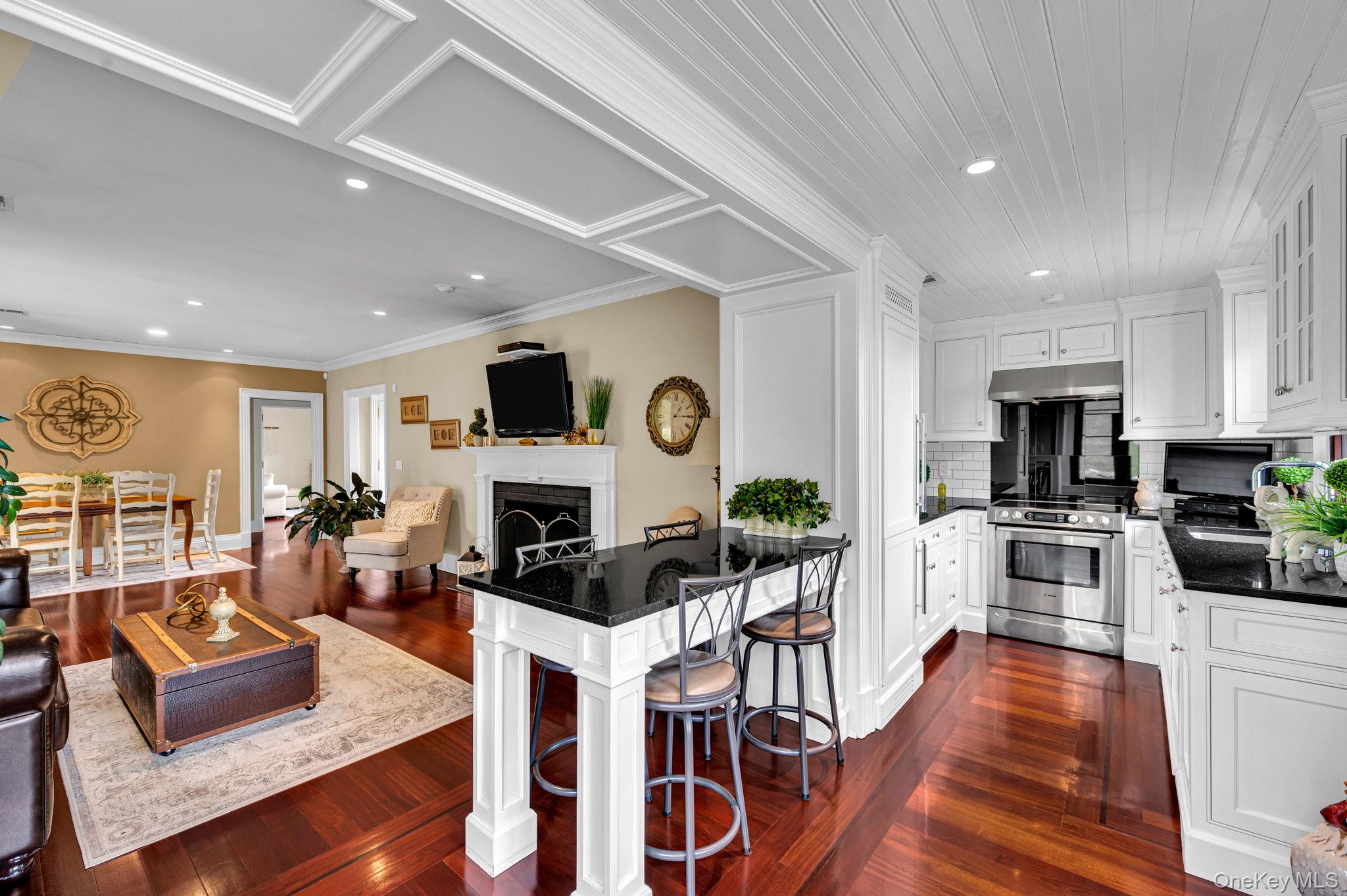717 Short Beach Road St. James, NY 11780 - Photo 42 of 47 a living room with fireplace furniture and a view of kitchen
