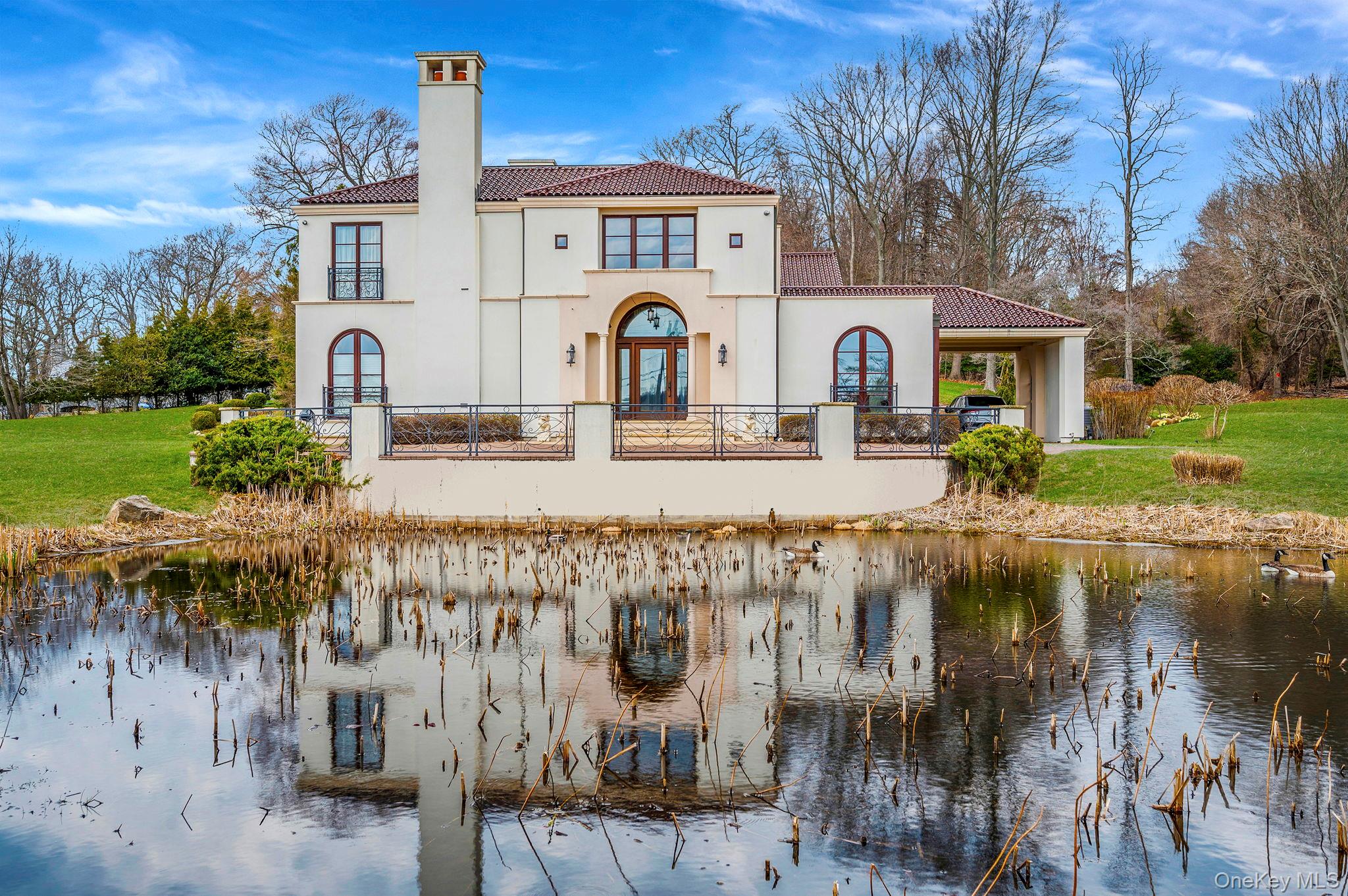 717 Short Beach Road St. James, NY 11780 - Photo 45 of 47 a front view of a house with garden and lake view
