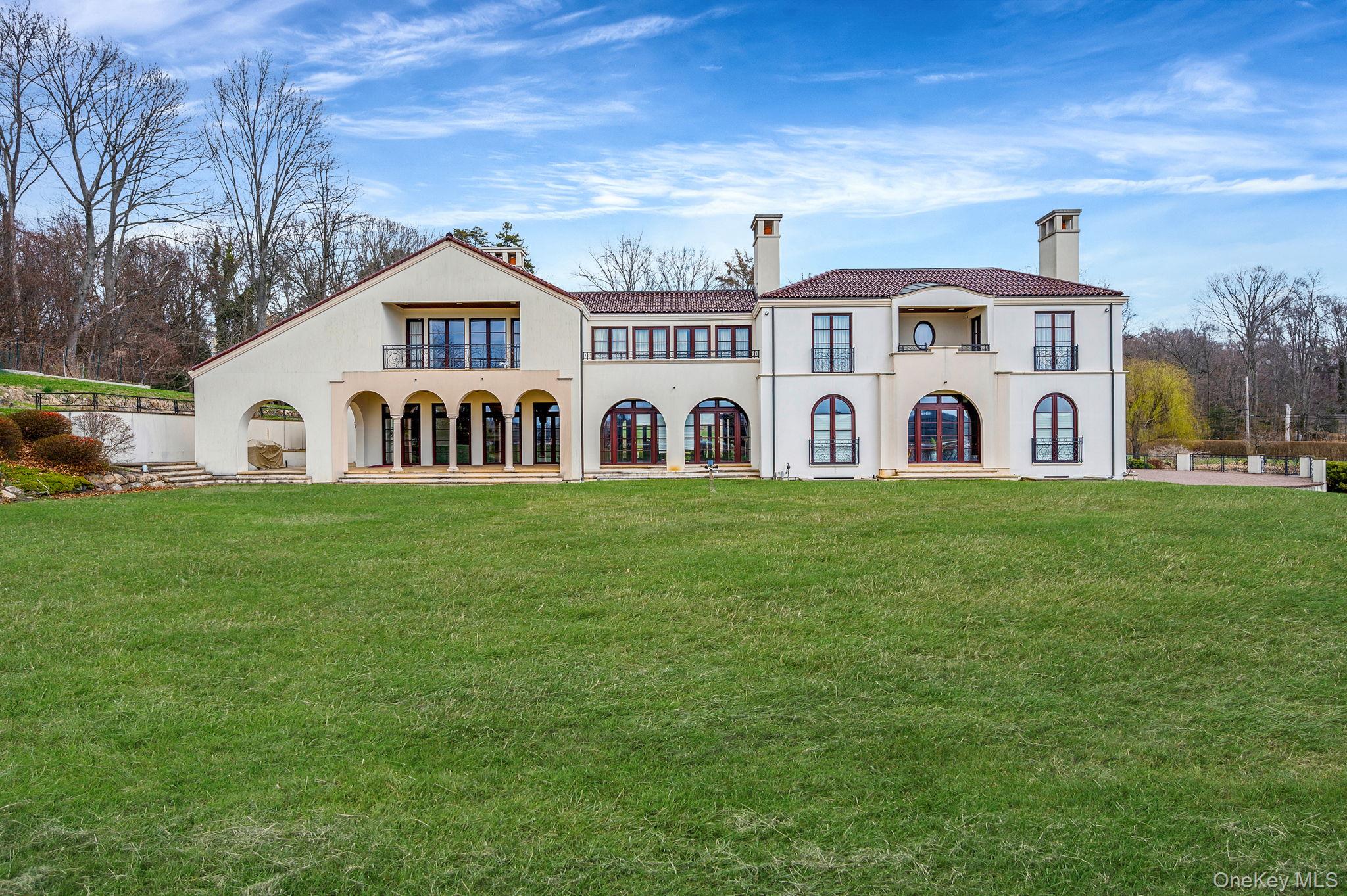 717 Short Beach Road St. James, NY 11780 - Photo 46 of 47 a view of a white house with a big yard and large trees