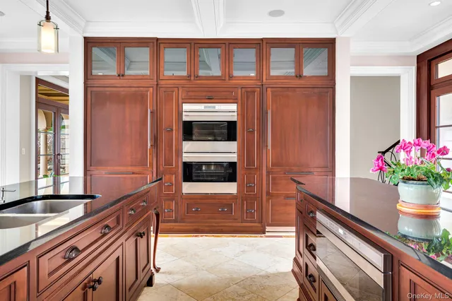 a kitchen with stainless steel appliances granite countertop a sink and a refrigerator