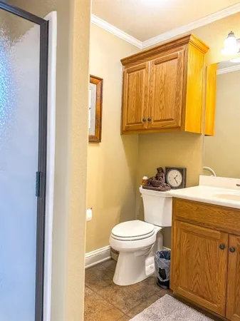 a bathroom with a toilet a sink and a mirror