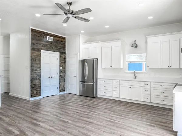 a kitchen with stainless steel appliances granite countertop a refrigerator and a stove top oven