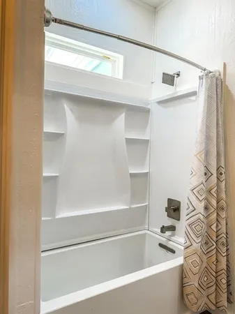 a bathroom with a bathtub and a shower