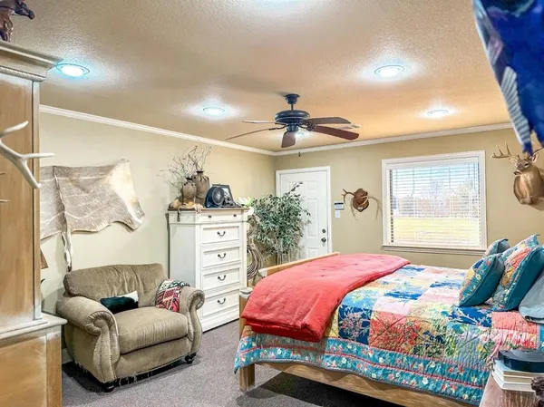 a bedroom with a bed couch and window
