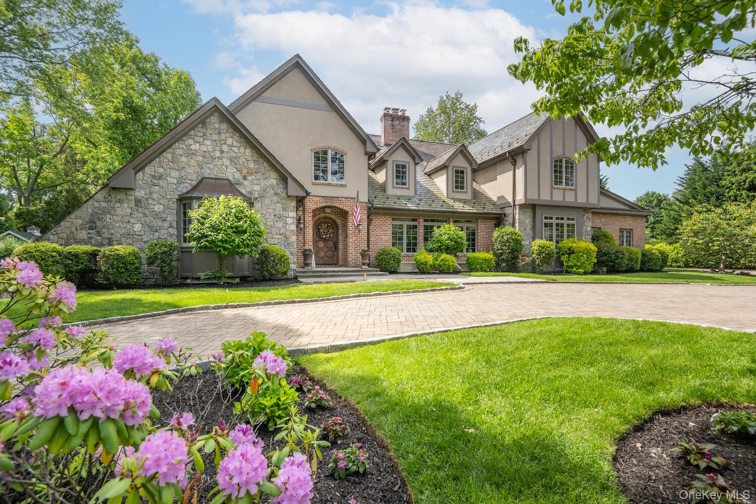 a front view of house with yard and green space