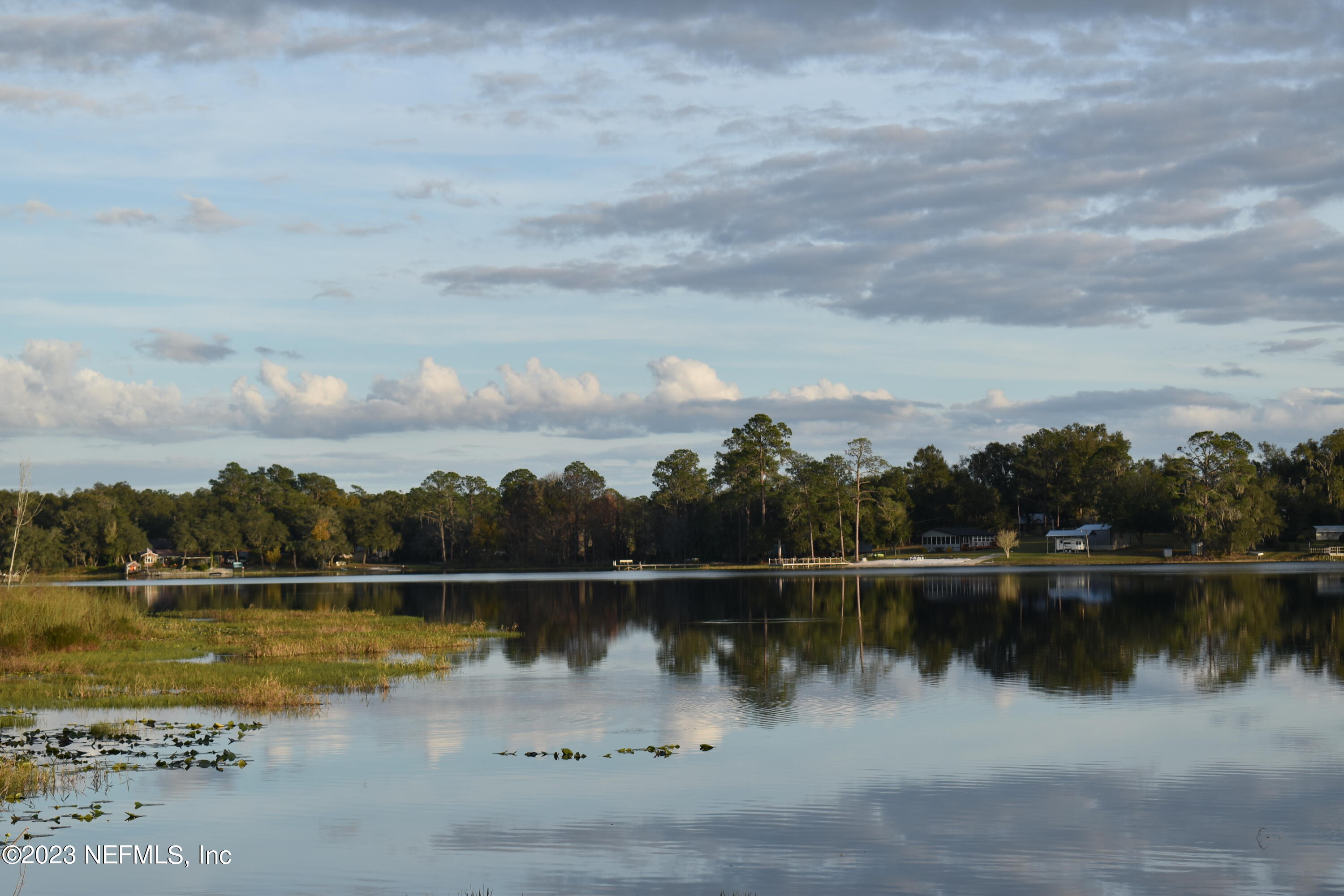 0 Simpson Drive Interlachen, FL 32148 - Photo 6 of 34 a view of a lake with houses in the back