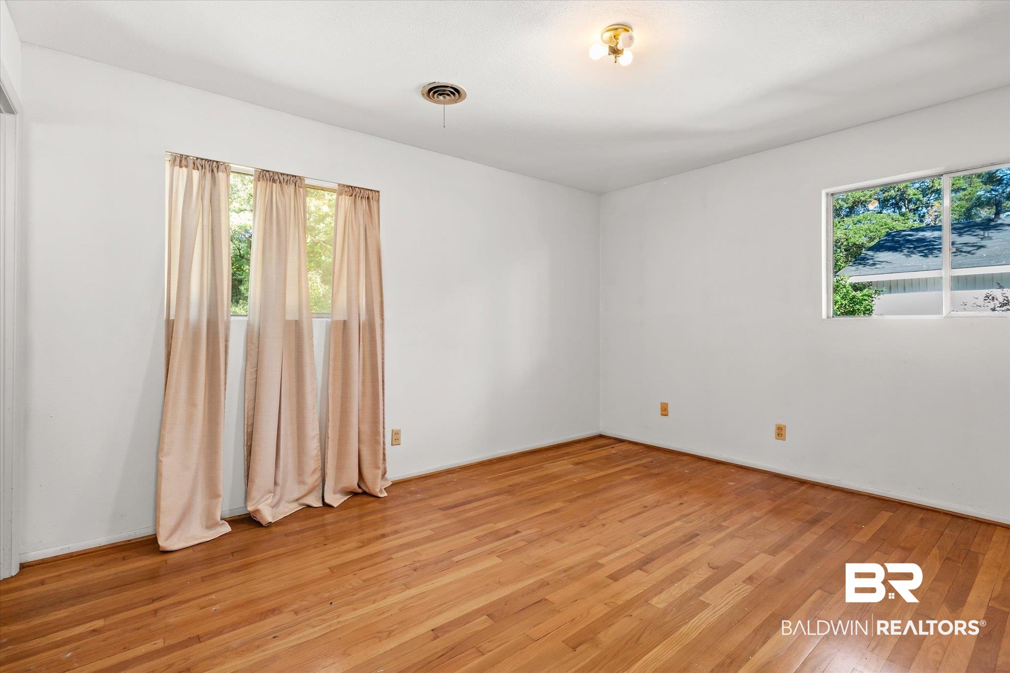 602 Markham Drive Mobile, AL 36609 - Photo 8 of 20 Unfurnished room with light wood-type flooring and a healthy amount of sunlight