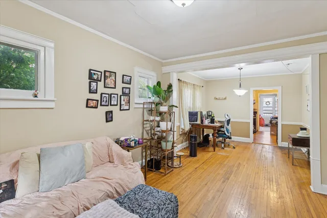 a living room with furniture and wooden floor