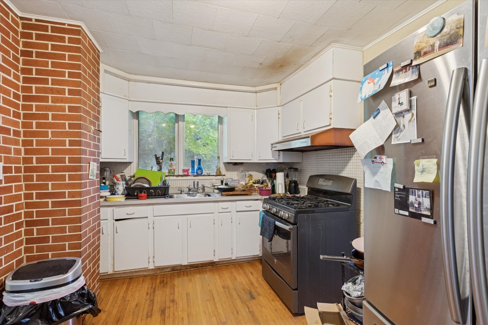 3731 Grove Avenue Berwyn, IL 60402 - Photo 7 of 14 a kitchen with stainless steel appliances a sink a stove a refrigerator cabinets and a window
