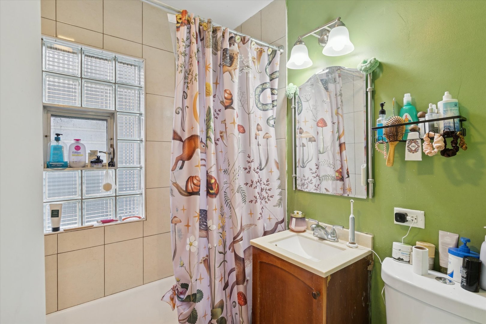 3731 Grove Avenue Berwyn, IL 60402 - Photo 8 of 14 a bathroom with a sink vanity mirror and shower