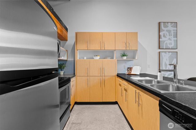 a kitchen with a sink and a refrigerator