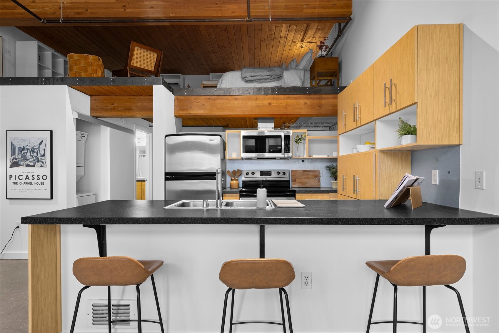 401 9th Avenue North, Unit 504 Seattle, WA 98109 - Photo 13 of 38 a kitchen with stainless steel appliances a sink a stove and a microwave