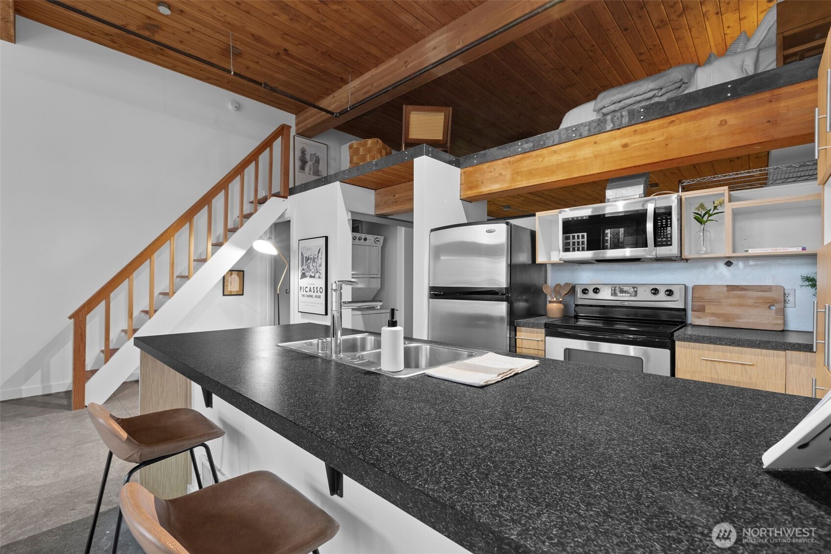401 9th Avenue North, Unit 504 Seattle, WA 98109 - Photo 14 of 38 a kitchen with stainless steel appliances granite countertop a sink a stove and a microwave