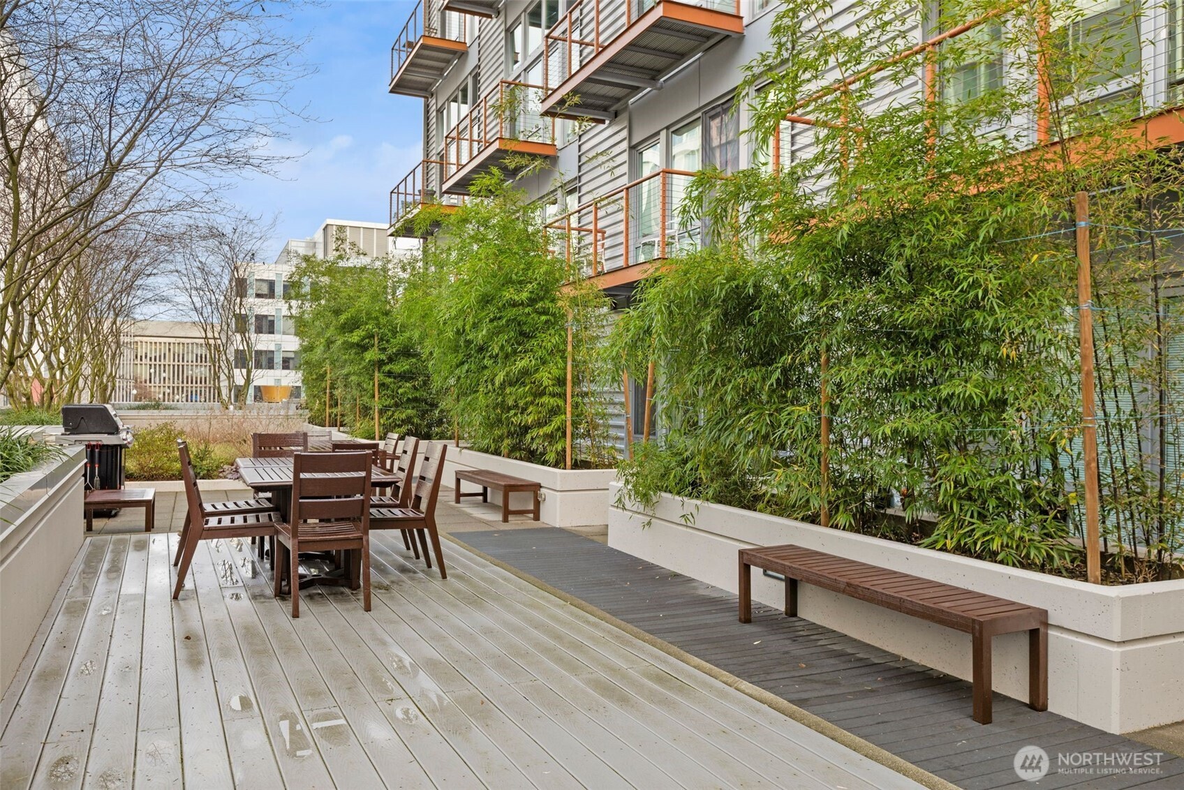 401 9th Avenue North, Unit 504 Seattle, WA 98109 - Photo 33 of 38 a roof deck view with table and chairs and wooden floor