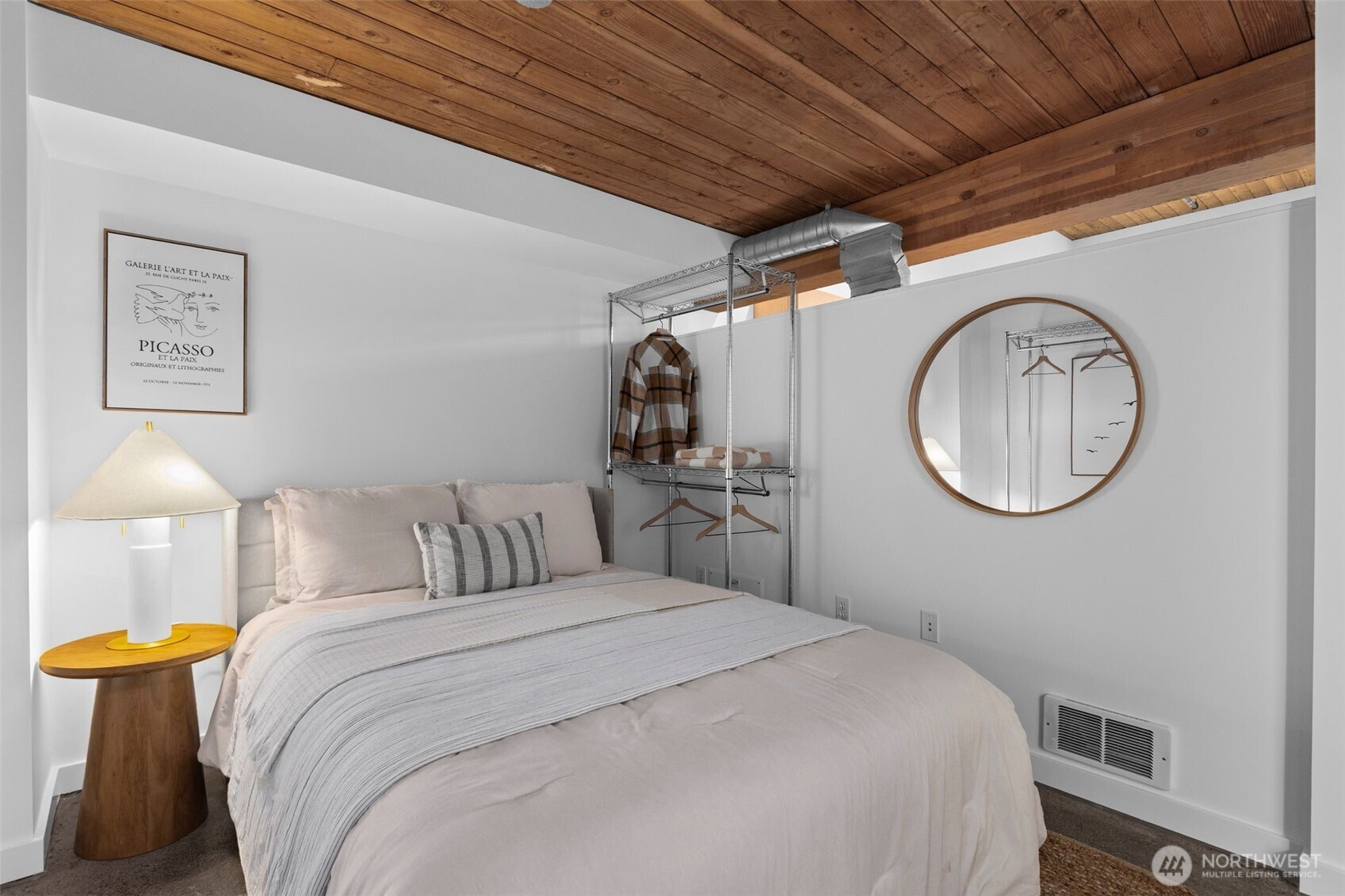 401 9th Avenue North, Unit 504 Seattle, WA 98109 - Photo 6 of 38 a bedroom with a bed and a chandelier