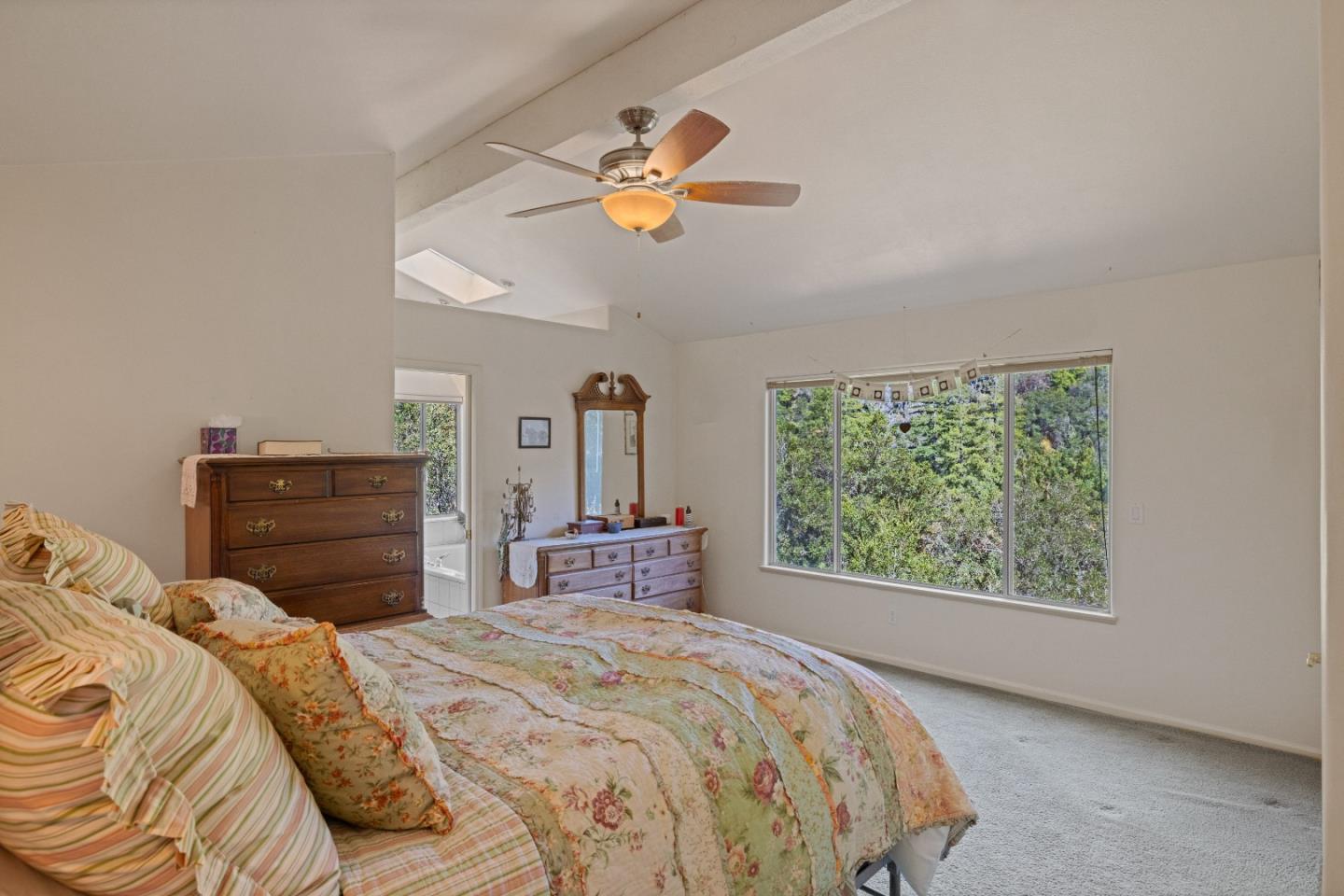 38621 Palo Colorado Road Carmel, CA 93923 - Photo 15 of 32 a bedroom with a bed and a chandelier
