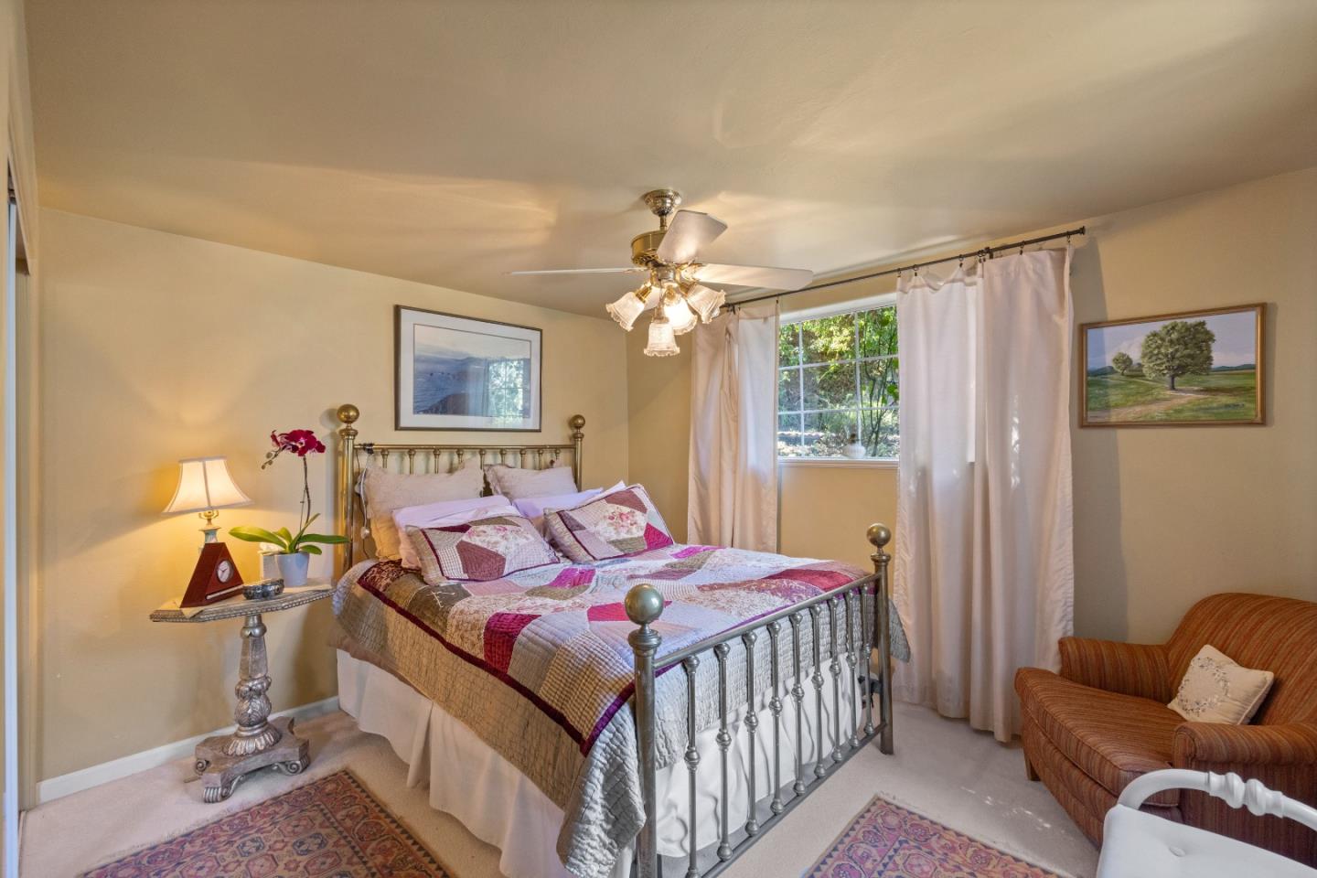 38621 Palo Colorado Road Carmel, CA 93923 - Photo 19 of 32 a bedroom with a bed and a chandelier