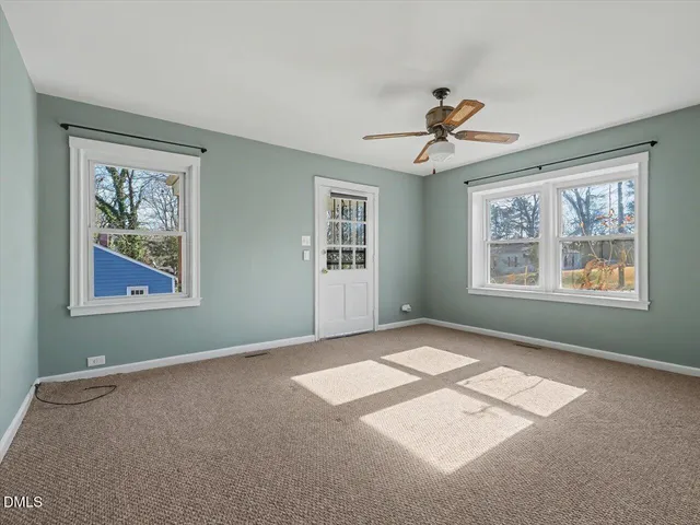 a view of a room with a ceiling fan
