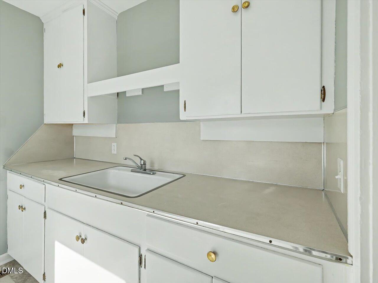 1501 Fairfax Road Durham, NC 27701 - Photo 16 of 42 a kitchen with a sink and cabinets