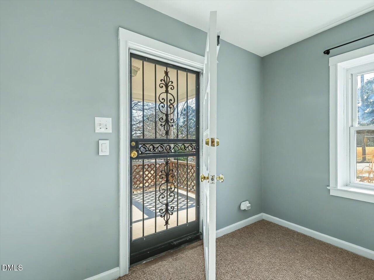 1501 Fairfax Road Durham, NC 27701 - Photo 9 of 42 an empty room with wooden floor and windows