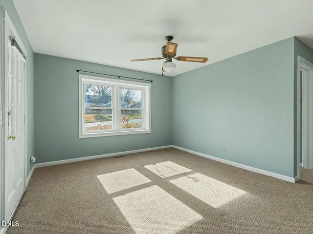 a view of an empty room with windows