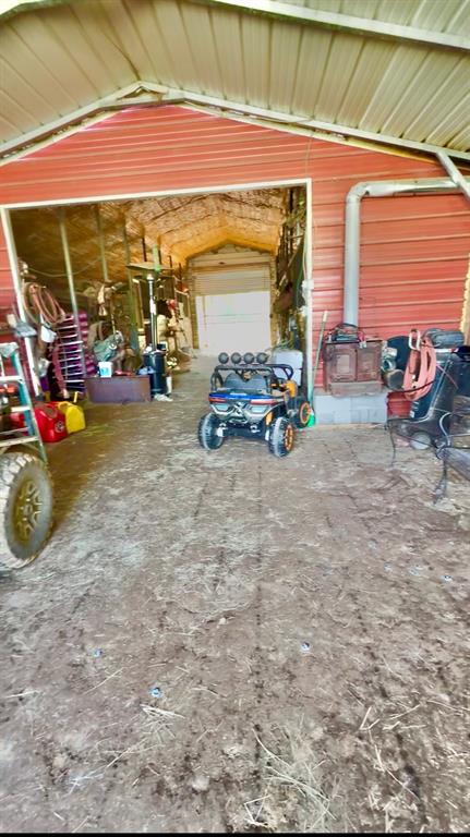 8261 County Road 381 Tyler, TX 75708 - Photo 17 of 40 a view of a garage with a car parked in it