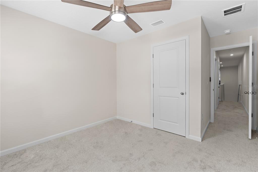 12003 Grizzly Lane New Port Richey, FL 34654 - Photo 26 of 43 an empty room with closet and a chandelier fan