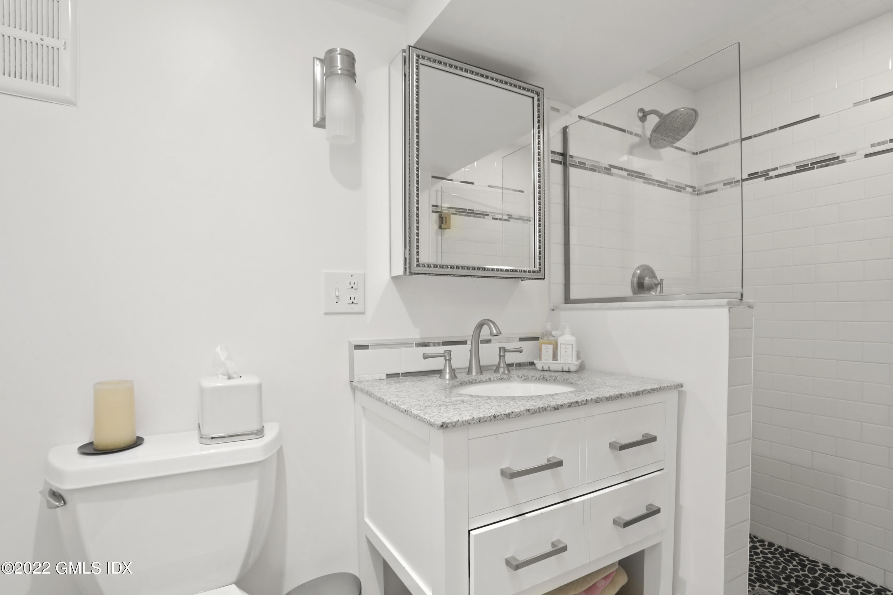 9 Frontier Road Cos Cob, CT 06807 - Photo 29 of 37 a bathroom with a granite countertop sink mirror and a toilet