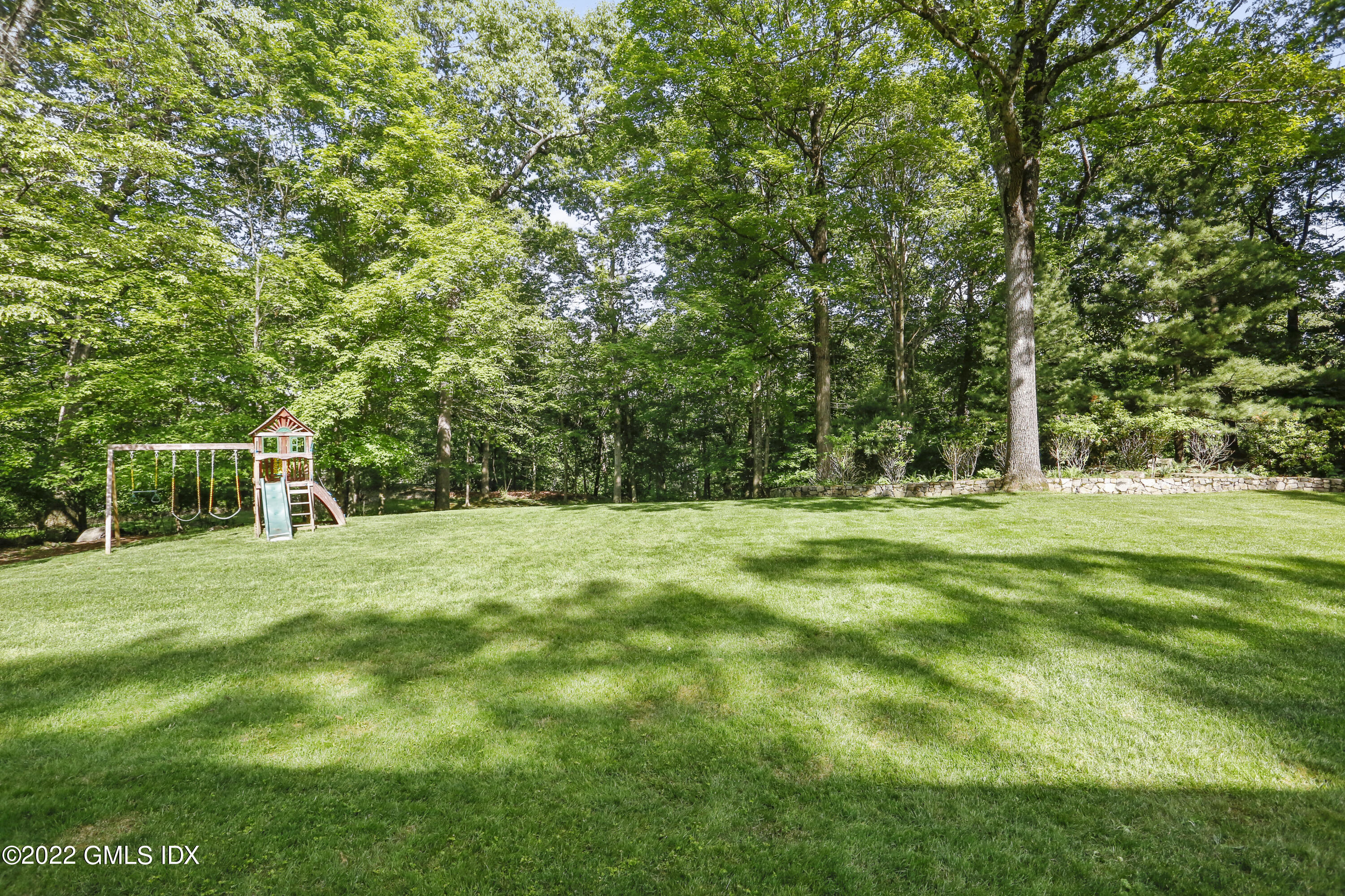9 Frontier Road Cos Cob, CT 06807 - Photo 32 of 37 a backyard of a house with trees