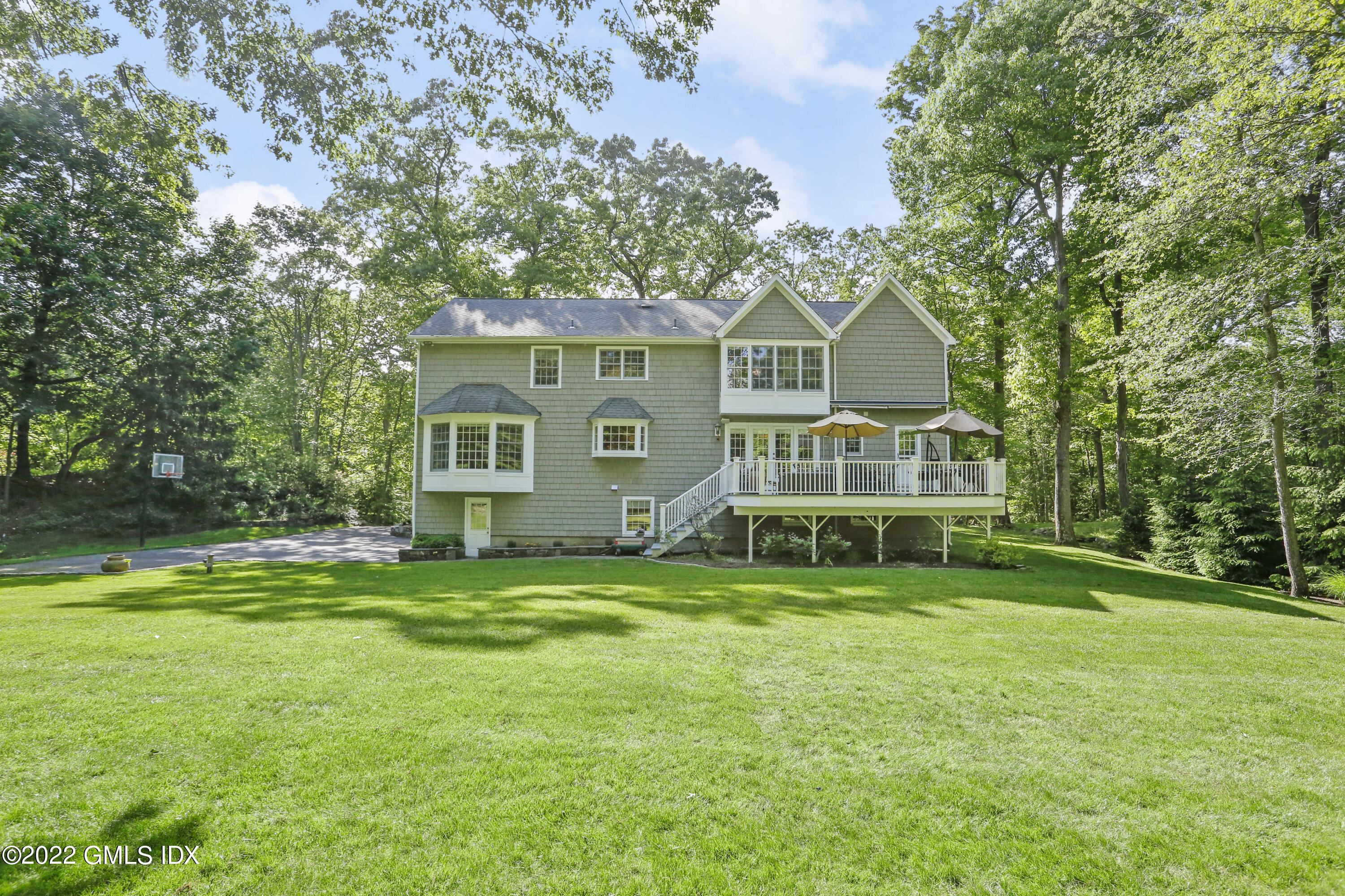 9 Frontier Road Cos Cob, CT 06807 - Photo 34 of 37 a view of a house with a big yard and large trees