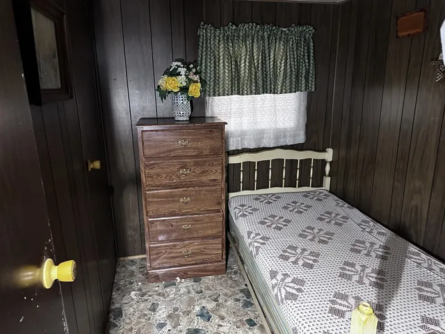 a bedroom with a bed and a dresser