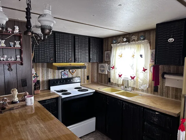 a kitchen with sink cabinets and stove
