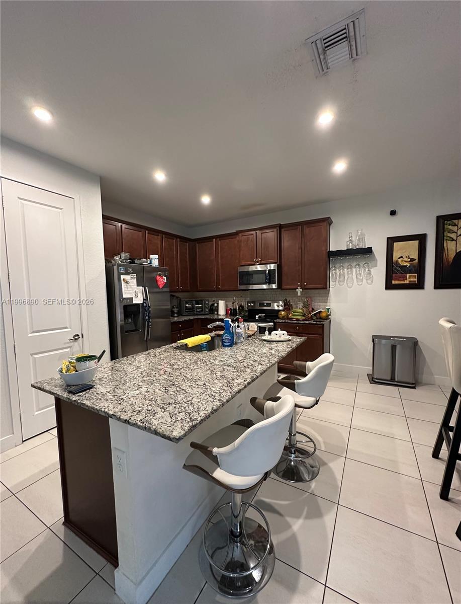 23552 Southwest 107th Place Homestead, FL 33032 - Photo 14 of 30 a room with lots of appliances and furniture