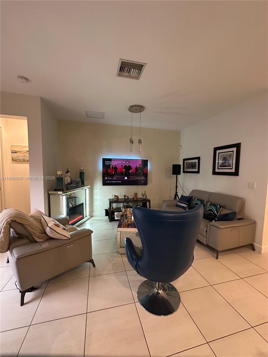 23552 Southwest 107th Place Homestead, FL 33032 - Photo 16 of 30 a living room with furniture and a flat screen tv