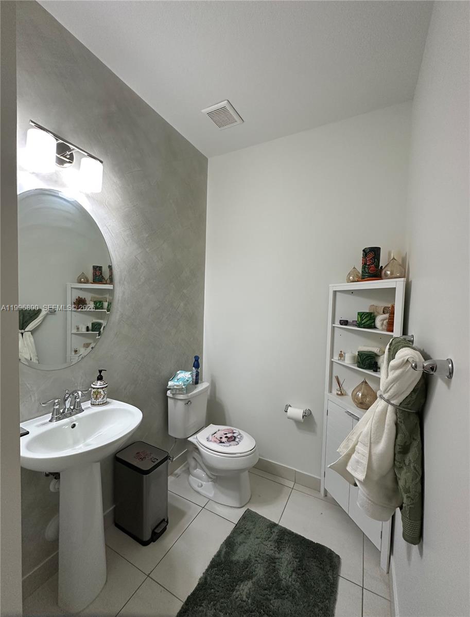23552 Southwest 107th Place Homestead, FL 33032 - Photo 17 of 30 a bathroom with a sink toilet and a mirror