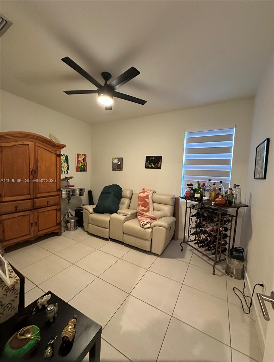 23552 Southwest 107th Place Homestead, FL 33032 - Photo 19 of 30 a living room with furniture a air conditioner and a window