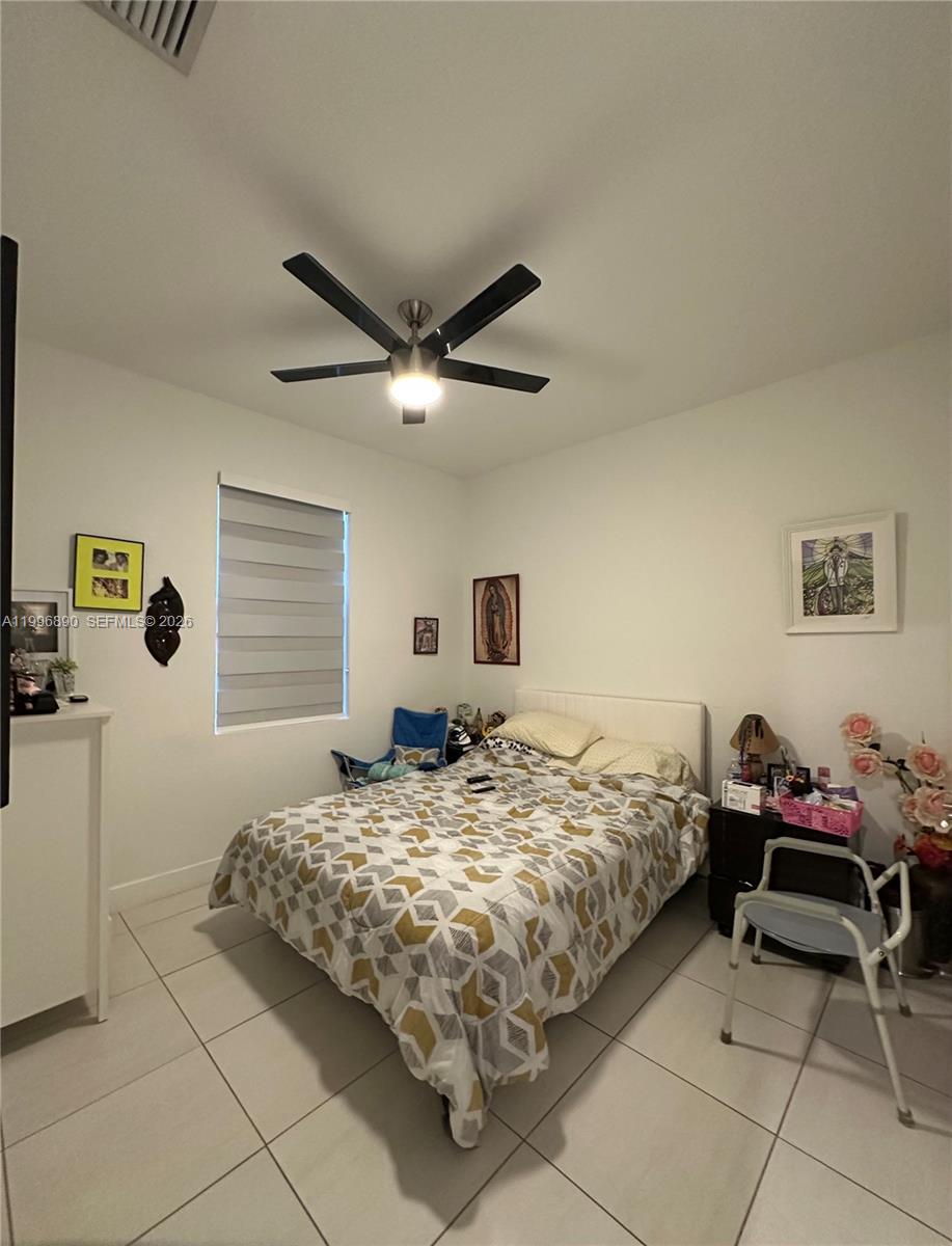 23552 Southwest 107th Place Homestead, FL 33032 - Photo 21 of 30 a bedroom with a bed and a window