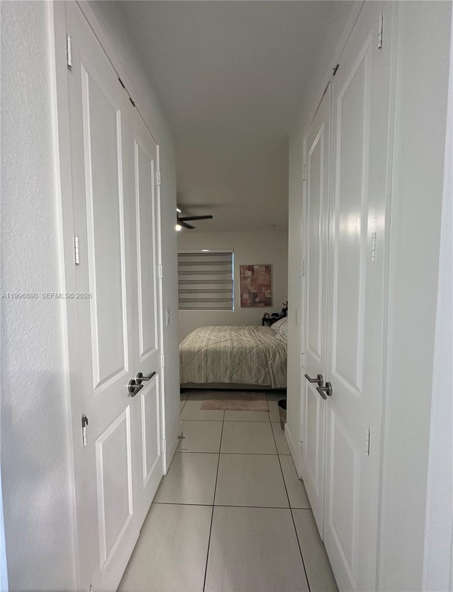 23552 Southwest 107th Place Homestead, FL 33032 - Photo 24 of 30 a view of a hallway with a bedroom