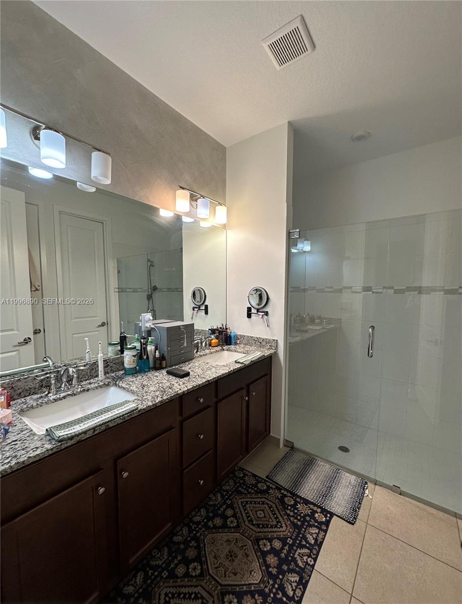 23552 Southwest 107th Place Homestead, FL 33032 - Photo 25 of 30 a bathroom with a double vanity sink and a mirror